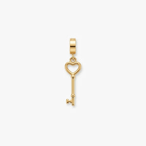A gold key-shaped pendant charm with a heart-shaped key head, shown on a clean white background.