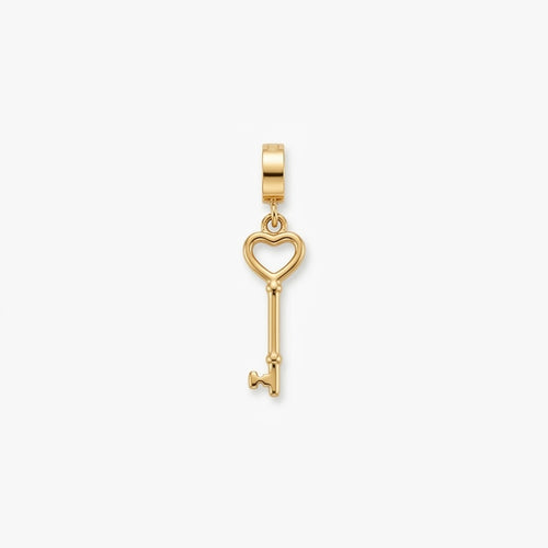A gold key-shaped pendant charm with a heart-shaped key head, shown on a clean white background.